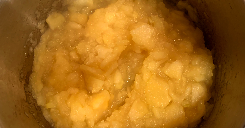 Applesauce after being mashed in a stainless steel pot