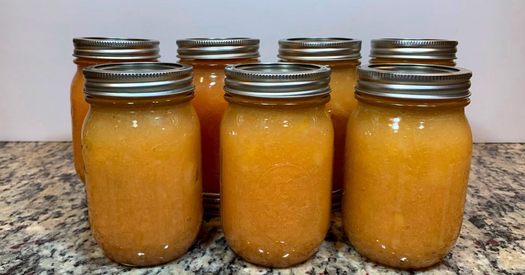 Seven Ball mason jars containing water bathed applesauce