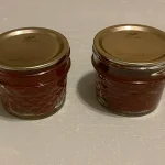 Two mason jars of Roasted Tomato Paste that has been Water Bath Canned.