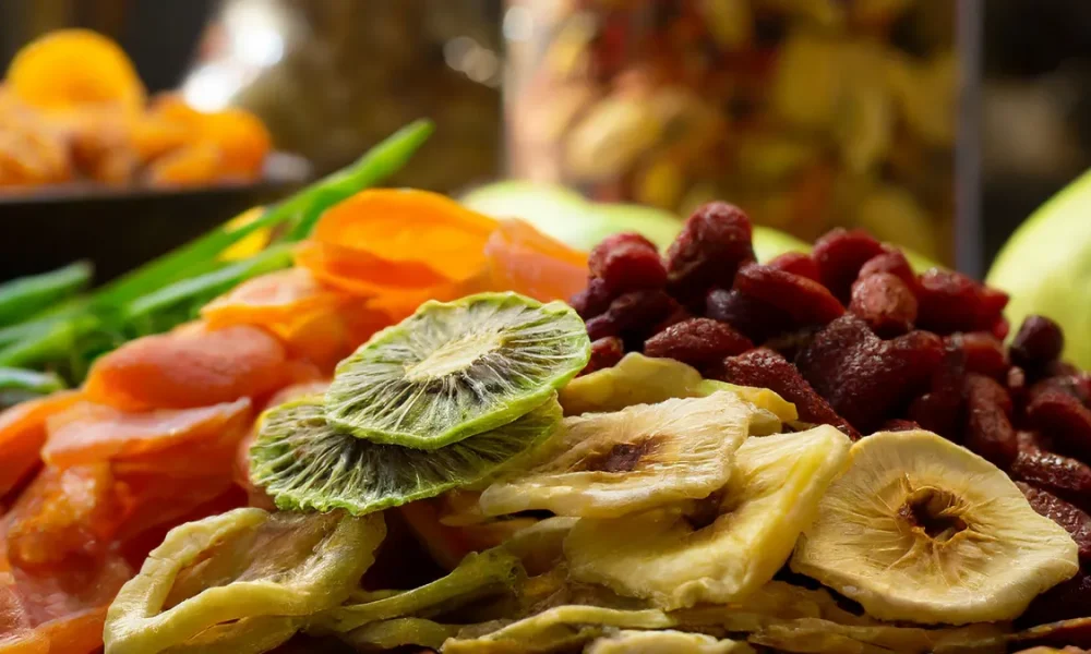 Multiple types of fruits (kiwis, mango, bananas, goji berries) that have been dehydrated.