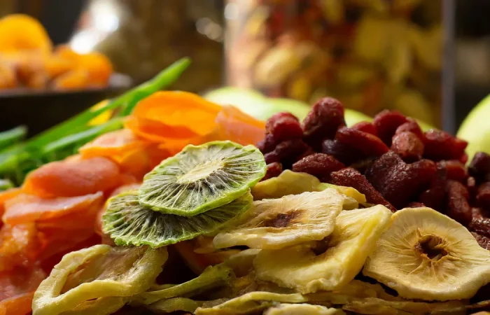 Multiple types of fruits (kiwis, mango, bananas, goji berries) that have been dehydrated.