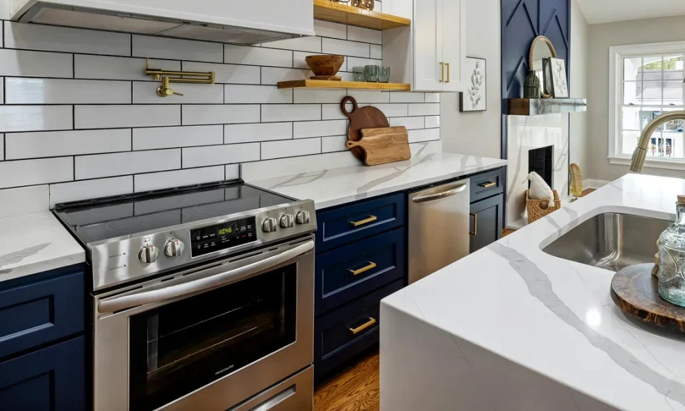 Glass topped stove in a navy blue and white kitchen