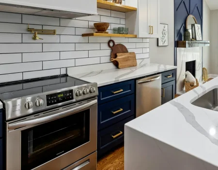 Glass topped stove in a navy blue and white kitchen