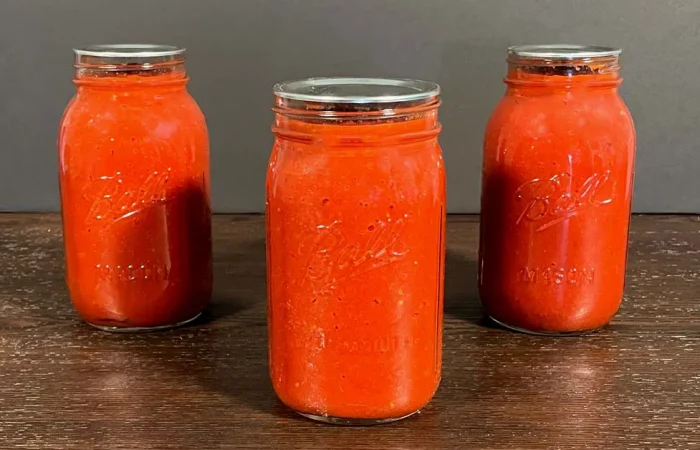 Water Bath Canning Tomato Sauce. Tomato sauce in three 1 quart mason jars