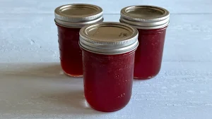 Three mason jars of strawberry jam.