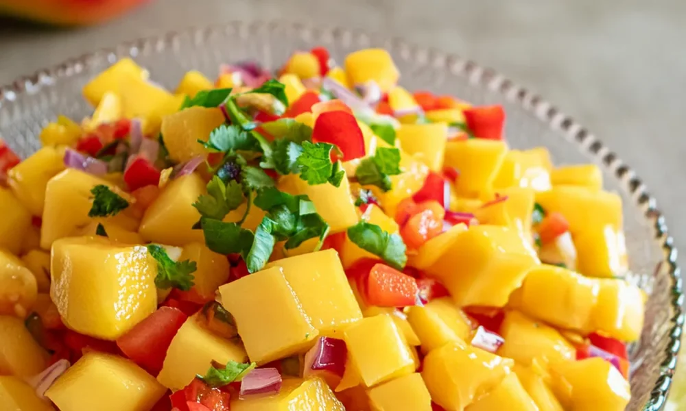 Mango Habanero Salsa with fresh cilantro in a glass bowl.