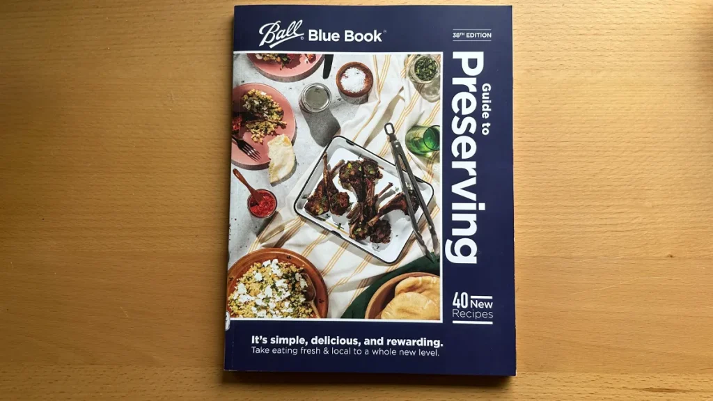 Image of the front cover of the Ball Blue Book 38th Edition Guide to Preserving.