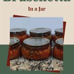 Pinterest Pin for How To Can Bruschetta In A Jar. Image of mason jars of bruschetta after being water bath canned.