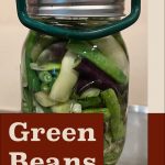 Pinterest Pin for Pressure Canning Green Beans. Image of a mason jar of green beans before being pressure canned.