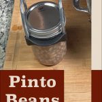 Pinterest Pin for Pressure Canning Pinto Beans. Image of a mason jar of pinto beans before being pressure canned.