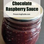 Pinterest Pin for How To Can Chocolate Raspberry Sauce. Image of a mason jar of chocolate raspberry sauce sitting on a dark surface.