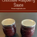 Pinterest Pin for How To Can Chocolate Raspberry Sauce. Image of two mason jars of chocolate raspberry sauce sitting on a dark surface.