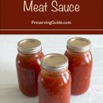 The image shows three jars of meat sauce with sealed metal lids, arranged on a white surface. The rich red color of the sauce indicates it is well-prepared and ready for storage. Above the jars, there is a brown banner with white and light brown text that reads: "How To Pressure Can Meat Sauce." Below this, the text "PreservingGuide.com" is displayed. This image is used for a guide or tutorial on how to safely pressure can meat sauce at home.