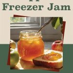 This image displays a jar of golden apple jam with a spoon and a slice of bread topped with jam, placed in a rustic kitchen setting with apples in the background. The text at the top reads, "How To Make Apple Freezer Jam," suggesting a recipe or guide for preparing homemade jam. The layout and imagery focus on the freshness of the apples and the simplicity of making freezer jam at home, conveying a cozy, homemade vibe.