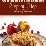 This image features a slice of apple, pear, and cranberry pie with a crumbly topping, served on a beige plate. In the background, whole apples and scattered cranberries add to the seasonal feel. The top portion of the image includes a brown banner with the text “Canning Apple Pear Cranberry Pie Filling Step-by-Step,” followed by “PreservingGuide.com.”