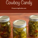 The image shows three mason jars filled with "Cowboy Candy," which are candied jalapenos, with sealed lids labeled "Ball SureTight." Above the jars, there is a brown banner with text that reads, "How To Can Cowboy Candy" and "PreservingGuide.com."