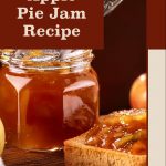 This Pinterest pin highlights an "Apple Pie Jam Recipe." The image showcases a jar of apple pie jam with a spoon resting inside and a piece of toast generously spread with the same jam. The rich amber color of the jam and the warm background with whole apples evoke a cozy, homemade feel. The text "Apple Pie Jam Recipe" is prominently placed in a red-brown box, while the website "PreservingGuide.com" is mentioned at the bottom, indicating a source for the full recipe. This pin emphasizes simplicity and warmth, ideal for those interested in home canning or trying new jam recipes.