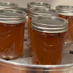 Six mason jars of Apple Jalapeno Jelly in a Steam Canner.