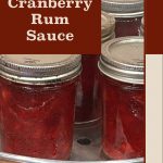 This image features a close-up of sealed jars filled with cranberry rum sauce, displayed on a canning rack. The overlay text, "Cranberry Rum Sauce," appears on a bold background, with a footer reading "PreservingGuide.com," reinforcing the source of the recipe and tips for this preservation method.