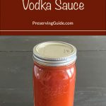 This image features a sealed jar filled with vibrant, homemade vodka sauce on a dark surface. The overlay text reads, "How To Can Vodka Sauce" along with a link to PreservingGuide.com, providing a clear and appealing visual for those looking to preserve their own sauces at home.