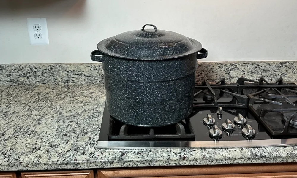 Ganiteware water bath canner sitting on a propane stove.