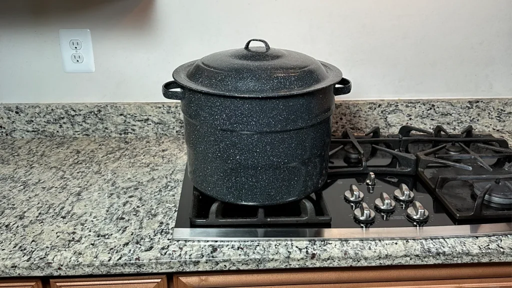 Ganiteware water bath canner sitting on a propane stove.