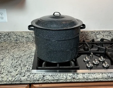 Ganiteware water bath canner sitting on a propane stove.