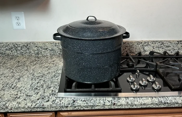 Ganiteware water bath canner sitting on a propane stove.