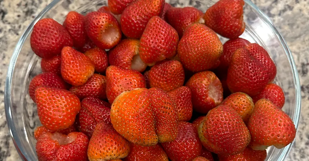 Fresh Hulled Strawberries sitting in a glass bowl